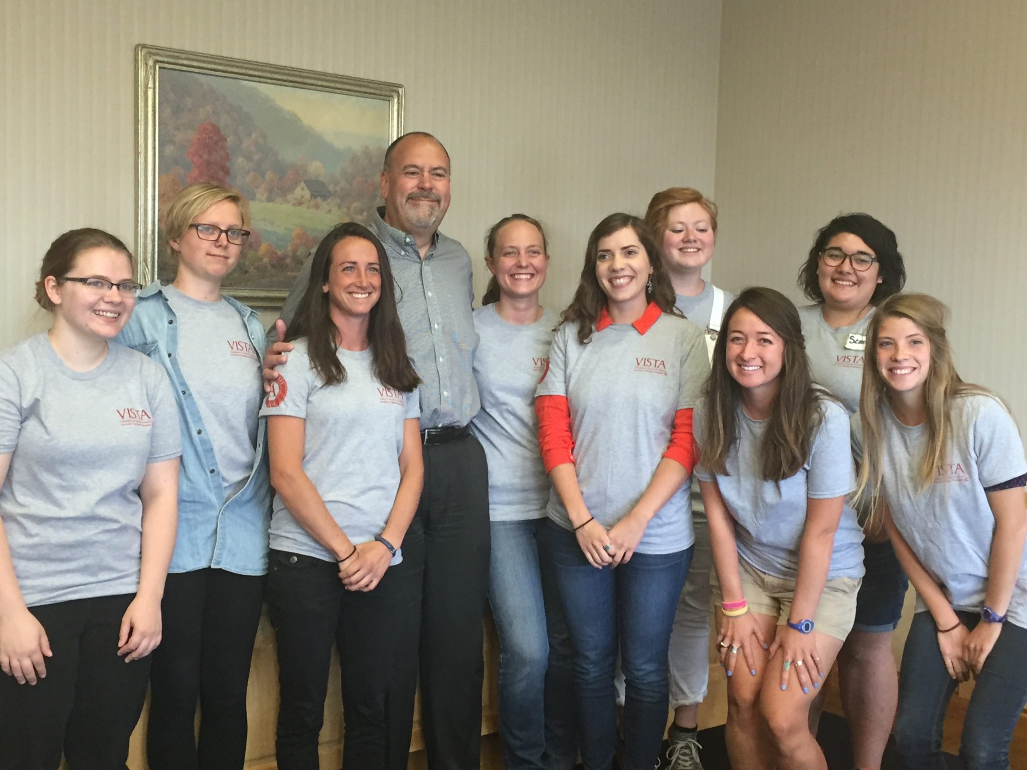 A group of AmeriCorps members standing with former Missoula mayor John Engen.
